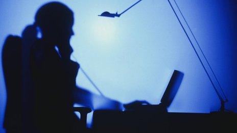 silhouette of woman at computer