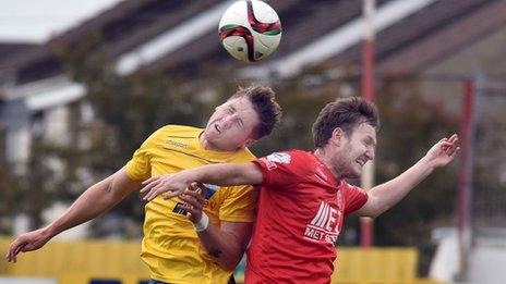 Gareth Rodger and Gary Twigg in aerial action