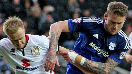 Cardiff's Aron Gunnarsson (right) competes with Ben Reeves of MK Dons