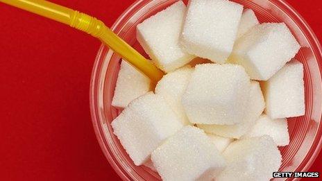 Sugar cubes in cup