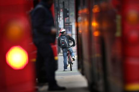 Cyclist between buses