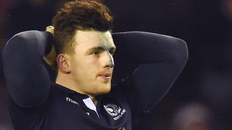 A dejected Scotland centre Matt Scott reflects on defeat by England