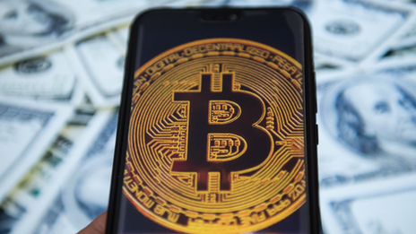 Bitcoin logo on a phone