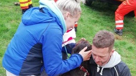 Dylan James and his fiance with Ruby the dog