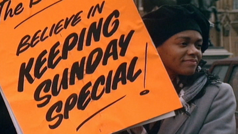 A protester holding a banner in support of the Keep Sunday Special campaign