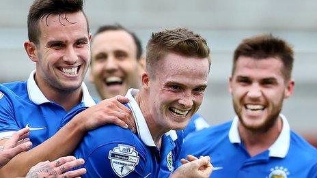 Linfield scorer Aaron Bruns is congratulated by Andrew Waterworth and Stephen Lowry