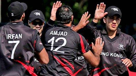 Hong Kong players celebrate the fall of an Irish wicket