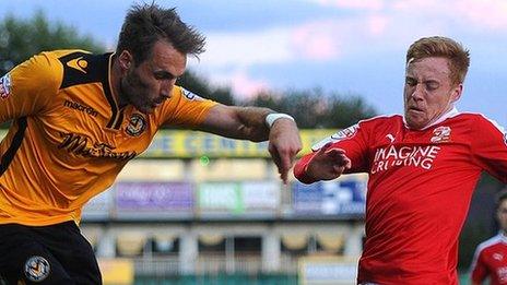 Alex Rodman of Newport County takes on Swindon's James Brophy