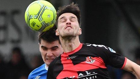 Crusaders' Declan Caddell in a race for possession with Jimmy Callacher of Linfield