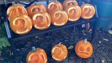 Pumpkins carved with the number 20