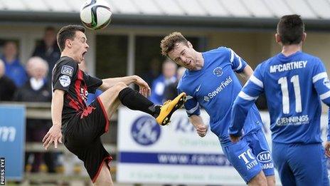 Crusaders winger Paul Heatley collides with Ballinamallard's Colm McLaughlin