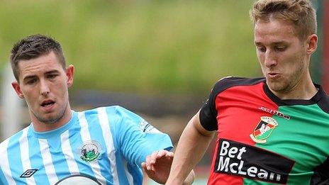 Daniel Hughes of Warrenpoint in action against Jonny Addis of Glentoran