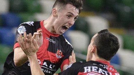 Gavin Whyte celebrates his goal with Crues' team-mate Paul Heatley at Windsor Park