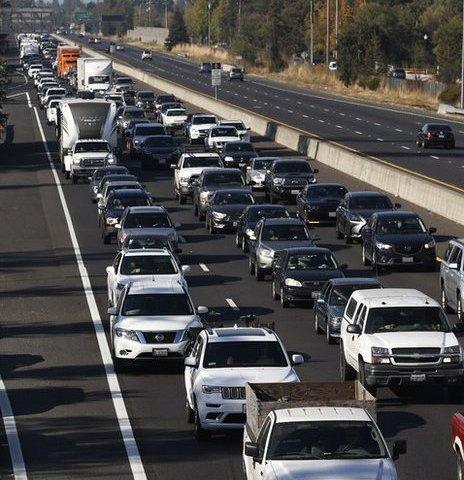 Vehicles travel south along Highway 101 as residents evacuate towns and cities in anticipation of the expected wind event on October 26, 2019 in Windsor, California