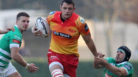 Aaron Shingler of Scarlets is tackled by Edoardo Gori