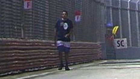 A spectator strolls on track during 2015 Singapore Grand Prix