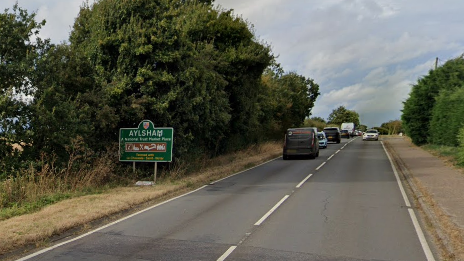 Green Aylsham road sign