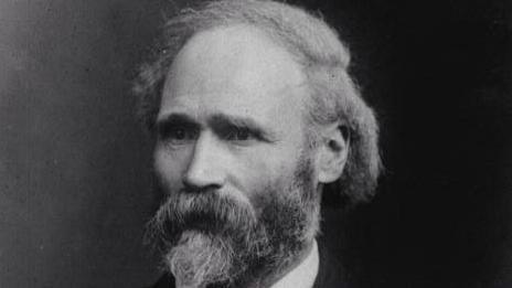A picture of Keir Hardie, which is in black and white. Hardie has a thick black beard and hair and is looking to the left of the camera.