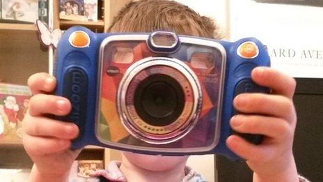 boy holding Vtech camera