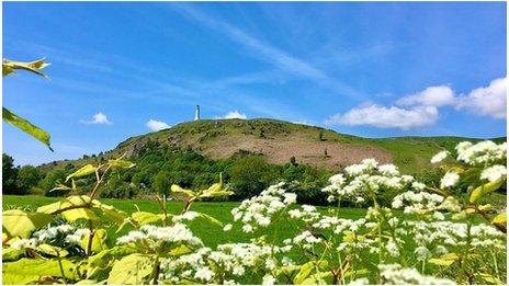 Blue skies over a hill with a lighthouse at the top