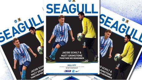 Shoreham air crash victims Jacob Schilt and Matt Grimstone feature on the cover of the match programme for Brighton's Championship match at home to Hull