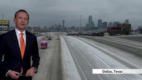 Nick Miller stands in front of an image of a Texan highway covered in ice