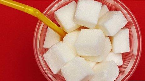 Sugar cubes in cup