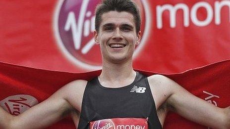 Callum Hawkins celebrates at the finish of the London Marathon