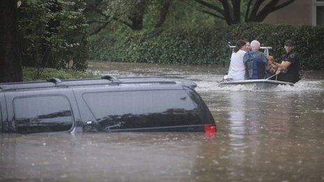 Storm Harvey: flooded street, submerged car, people in boat