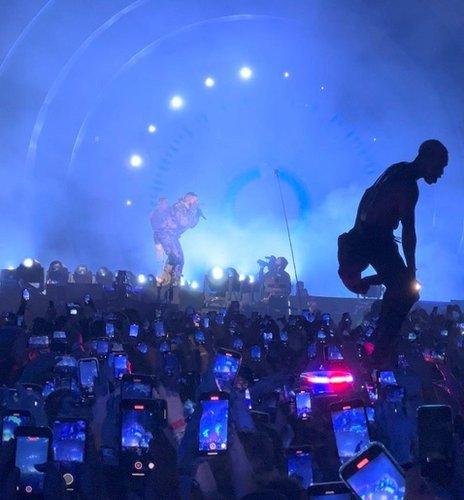 A man stands on an ambulance at the concert