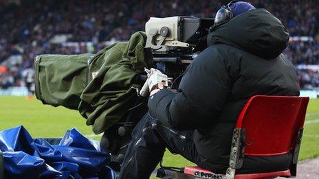 A cameraman at a Premier League game