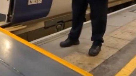 A bollard in front of a ramp leading up to a train