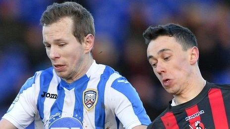 Coleraine's Johnny Watt in action against Paul Heatley of Crusaders