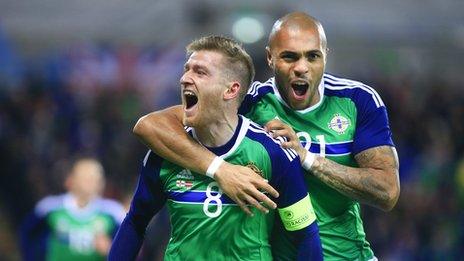 Steven Davis celebrates his goal with substitute Josh Magennis