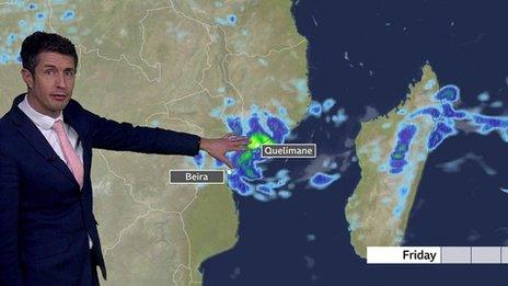 Chris Fawkes standing in front of a weather map of Mozambique showing Cyclone Freddy