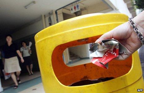 Litter is put in a bin in Singapore