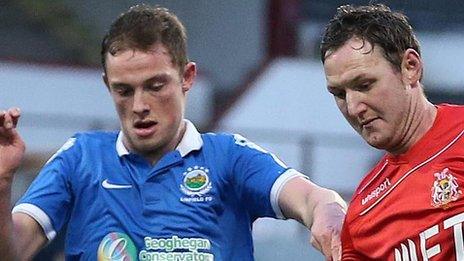 Linfield's Reece Glendinning in action against Gary Twigg of Portadown