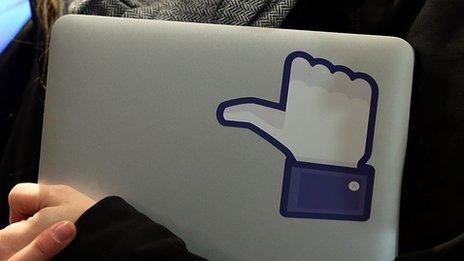 laptop with Facebook thumbs up