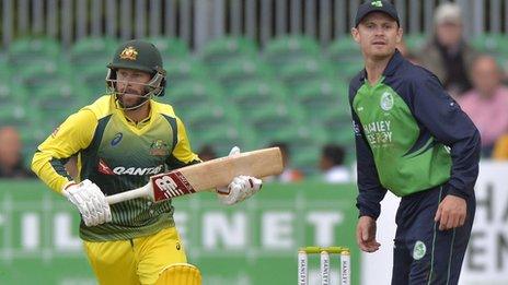 Australia batsman Matthew Wade plays a shot as Ireland captain William Porterfield looks on