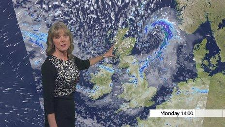 Louise Lear stands in front of a weather map of the UK for Tuesday