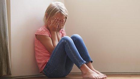 Girl covering her face with her hands