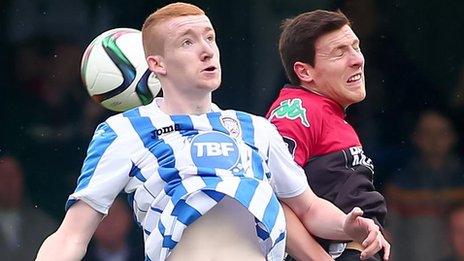 The ball beats Coleraine's Rodney Brown and Glens opponent Willie Garrett