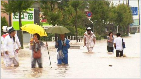 People walking through floods in Japan