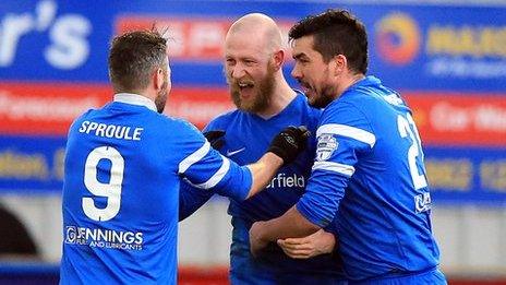 Stephen O'Flynn is congratulated by Ballinamallard players