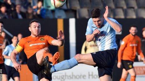 Carrick's Aaron Harmon challenges Michael Ruddy of Ballymena