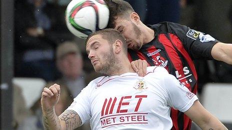 Ports striker Darren Murray and Josh Robinson contest a high ball