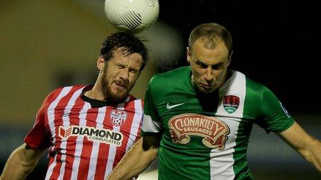 Derry captain Ryan McBride beats Cork's Dan Murray to the high ball