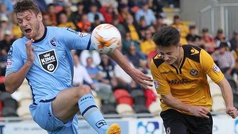 Newport County striker Aaron Collins heads toward goal