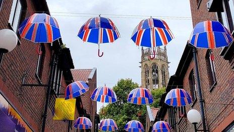 Union flag umbrella bunting against cloudy skies