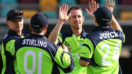 Alex Cusack celebrates taking a wicket